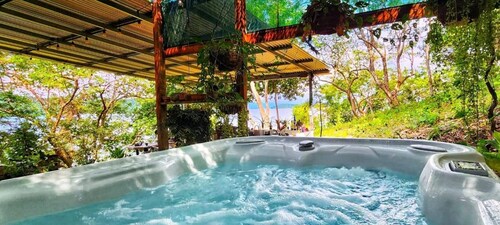 Teak house in a forest above the beach