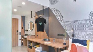A modern kitchen with a wooden countertop, a hanging shirt, and a wall mural. - lyf Farrer Park Singapore (Singapore)