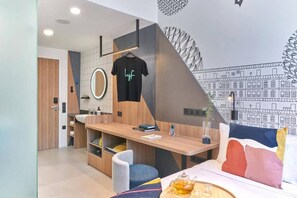 A modern kitchen with a wooden countertop, a hanging shirt, and a wall mural. - lyf Farrer Park Singapore (Singapore)