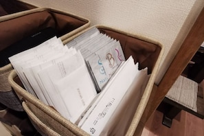 A storage bin filled with various documents and a black object. - [Mina's SamuraiHouse] 1 house (4 bedrooms/9 beds/1 parking lot) (Takayama)