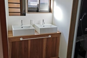A bathroom with two white sinks, wooden cabinetry, a towel rack, and a window above the sinks. - [Mina's SamuraiHouse] 1 house (4 bedrooms/9 beds/1 parking lot) (Takayama)