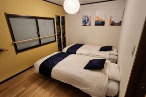 A bedroom with two beds, a window, and a door. - [Mina's SamuraiHouse] 1 house (4 bedrooms/9 beds/1 parking lot) (Takayama)