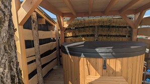 A wooden hot tub under a pergola with a wooden fence and a tree. - Tiny house-style chalet with private spa on the Alsace border (Zilling)