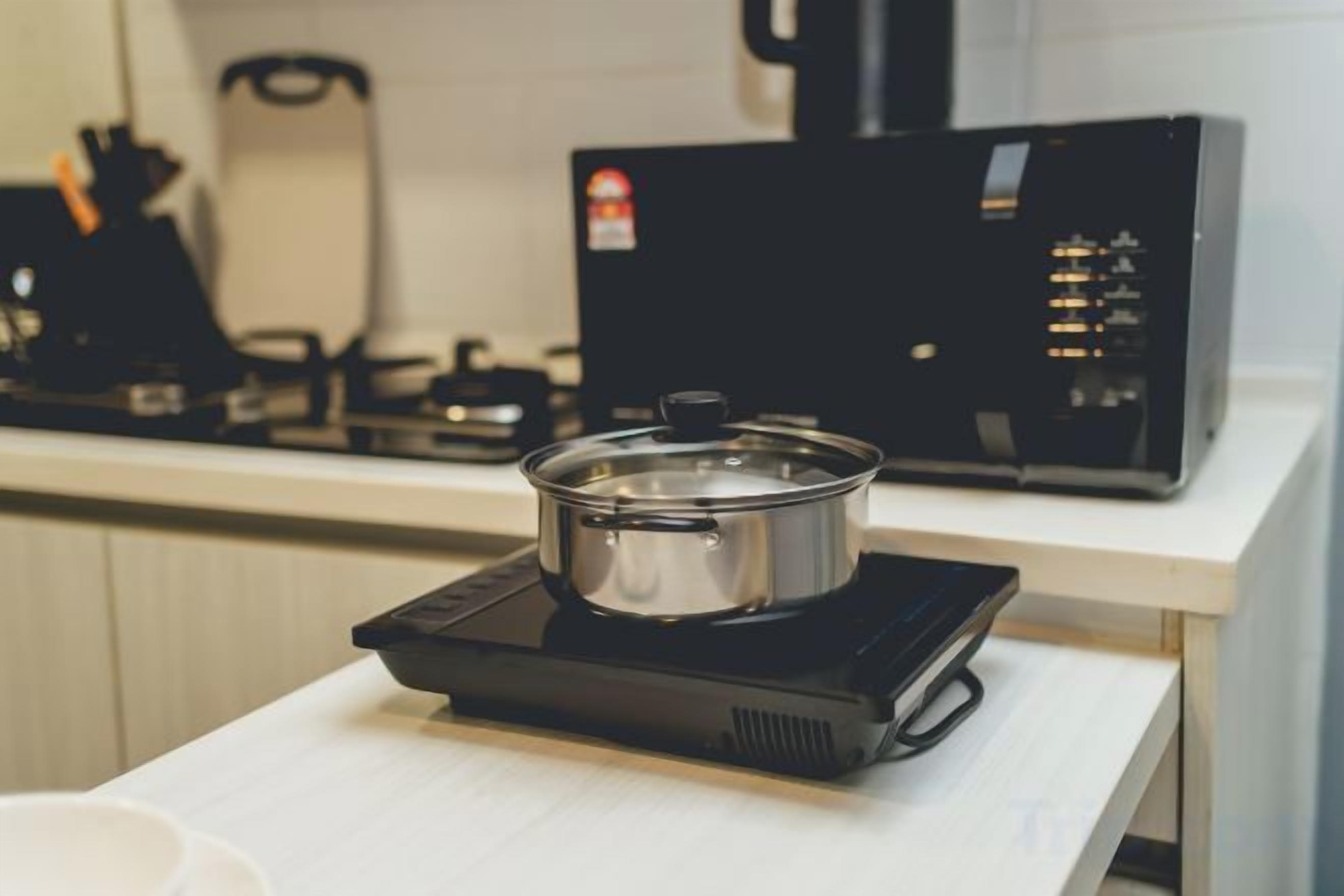 A kitchen with a stovetop and a microwave.