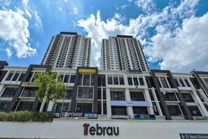 A multi-story building with commercial signage, including '1ebrau' and 'Hotel Interio.' - 1Tebrau Laconic Lux Suite 1BR nr Columbia (Johor Bahru)