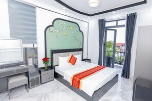 A modern bedroom with a bed, bedside table, and a TV. - Phu Gia Hotel 2160 Huynh Tan Phat (Ho Chi Minh City)