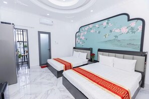 A hotel room with two beds, a large painting on the wall, and a view of the outdoors. - Phu Gia Hotel 2160 Huynh Tan Phat (Ho Chi Minh City)
