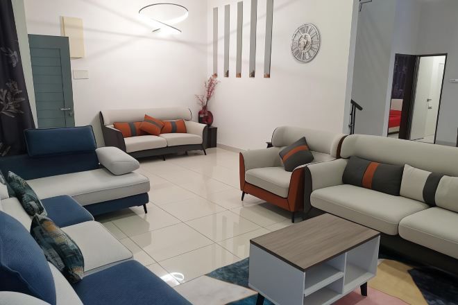 A modern living room with a sofa set, a coffee table, and a decorative vase.