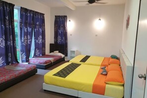 A bedroom with two beds, a nightstand, and a window with curtains. - Shamrock Beach Villa Penang CORNER No31 Sleeps 31 (Tanjung Bungah)