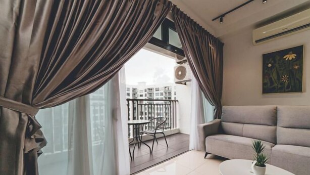 A modern living room with a sofa, a small table with a plant, and a balcony with a table and chairs. - Perling 8scape 3BR Comfy Zone nr Bukitindah/Sutera (Johor Bahru)