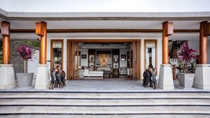 A hotel entrance with a covered porch, large potted plants, and a view into the interior. - Villa ZeniMo, Surin Beach, pool, 9 BR 18 guests (Phuket)