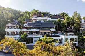 A multi-story building with a traditional architectural style, surrounded by lush greenery. - Villa ZeniMo, Surin Beach, pool, 9 BR 18 guests (Phuket)