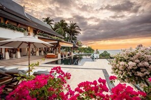 A resort with a pool, lounge chairs, and a sunset view. - Villa ZeniMo, Surin Beach, pool, 9 BR 18 guests (Phuket)