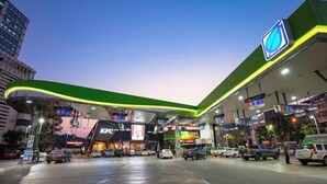 A gas station with multiple fuel pumps, a KFC restaurant, and various shops. - My Sukhumvit Villa (Bangkok)