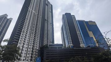 A high-rise building with a modern architectural design, featuring a prominent vertical structure and a mix of glass and concrete facades.