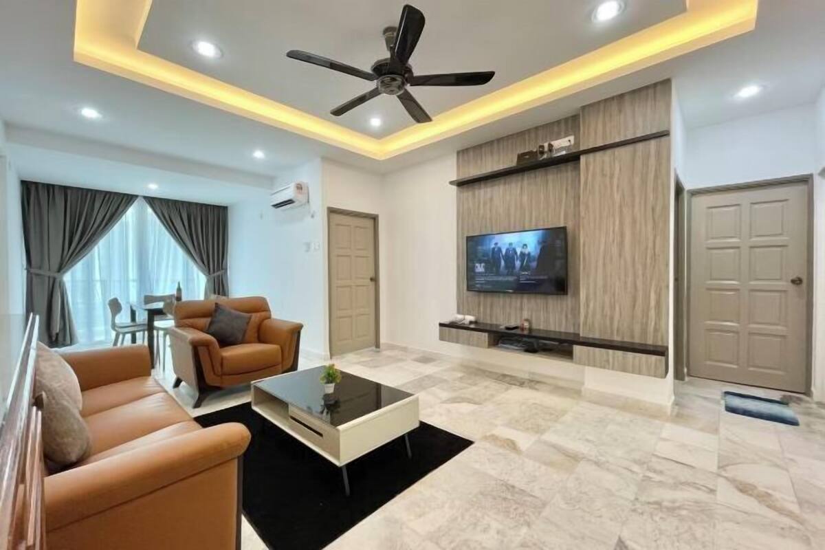 A modern living room with a ceiling fan, a flat-screen TV, a sofa, a coffee table, and a TV stand.
