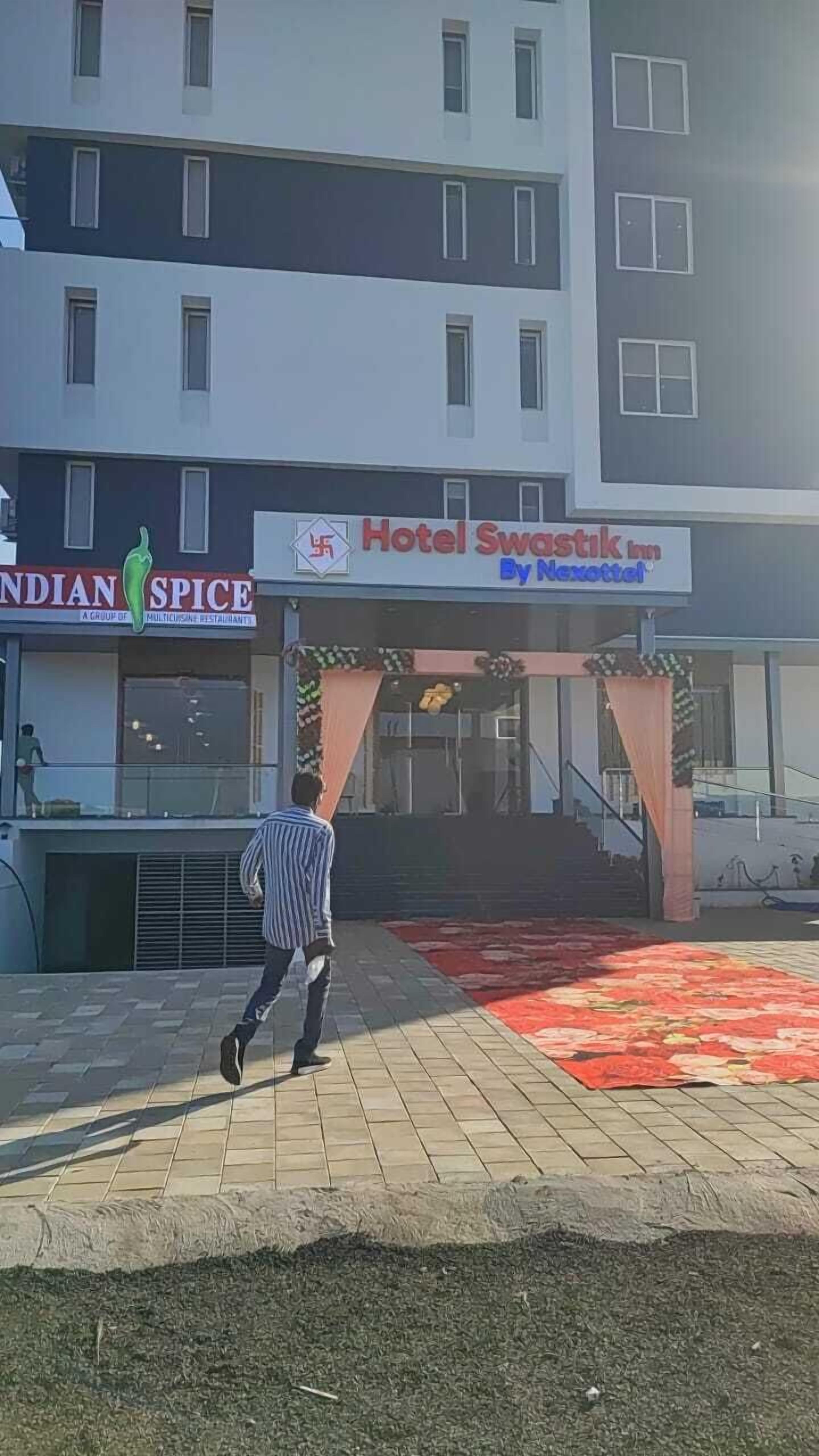 A hotel entrance with a sign for 'Hotel Swastik Inn By Netrattal'.