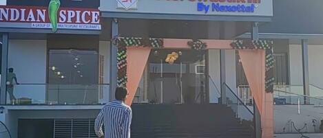 A hotel entrance with a sign for 'Hotel Swastik Inn By Netrattal'.
