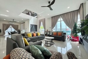 A modern living room with a sofa set, a coffee table, and a dining area. - Private Pool Retreat, 6BR Langkawi Villa by Zervin (Langkawi)