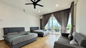 A modern bedroom with a large bed, a smaller bed, a sofa, and a ceiling fan. - Private Pool Retreat, 6BR Langkawi Villa by Zervin (Langkawi)