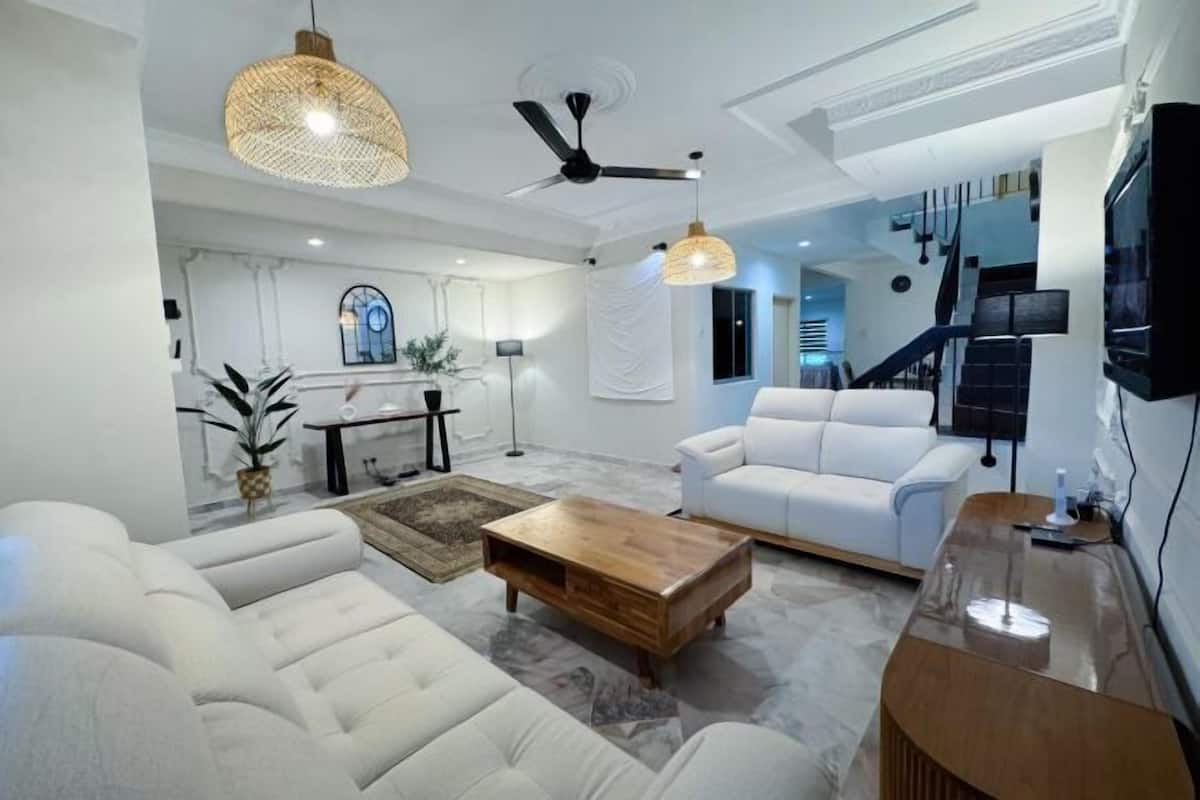 A modern living room with a white sofa, a wooden coffee table, and a ceiling fan.