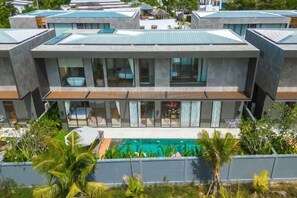 A modern multi-story building with a swimming pool, large windows, and a flat roof. - Long One A5 (Phuket)