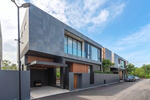 A modern two-story building with a flat roof, large windows, and a covered outdoor area. - Long One A5 (Phuket)