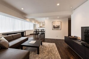 Un salon moderne avec un canapé, une table basse et un meuble pour la télévision.