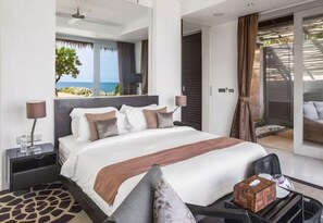 A modern hotel room with a large bed, a nightstand, a lamp, and a view of the ocean. - Sangsuri Villa 1 (Koh Samui)
