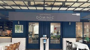 A restaurant named 'DOMINIC' with a modern European design, featuring a blue exterior, white brick walls, and a glass entrance. - Anggun KLCC 1BR @KL City monorail Netflix 1CP (Kuala Lumpur)