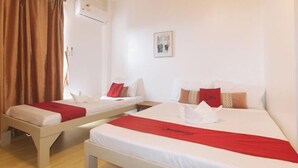 Two single beds with red bedspreads, white pillows, and a red blanket. - RedDoorz @ Garvs Boutique Hotel Boracay (Boracay Island)