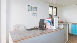 A small office with a desk, computer, and a window. There are three framed certificates on the wall. - RedDoorz @ Garvs Boutique Hotel Boracay (Boracay Island)