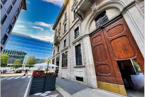 A historic building with a large wooden door and a modern glass building in the background. - The Model's Apartment - Urban Loft 56 Moscova - Fashion & Design Heart of Milano (Milan)
