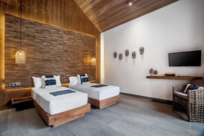 A modern hotel room with two beds, a flat-screen TV, and a wooden accent wall. - Villa Zen Paradise by BaliSuperHost (Bali)