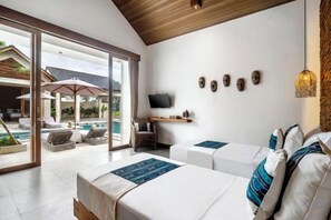 A hotel room with a pool view, a TV, and a sliding glass door. - Villa Zen Paradise by BaliSuperHost (Bali)