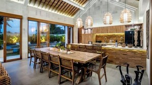 A spacious kitchen with a wooden island, large windows, and pendant lights. - Villa Zen Paradise by BaliSuperHost (Bali)