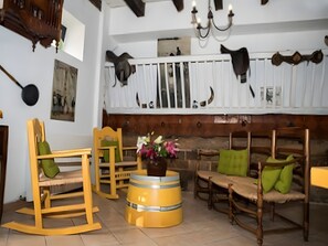 A room with wooden furniture, a chandelier, and decorative items on the walls. - Guest Room 'Chambre Marcel Pagnol' with Shared Terrace, Wi-Fi and Air Conditioning (Bernis)