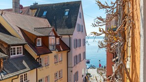 A hotel with a view of the sea, a balcony, and a sign indicating a restaurant. - Room 'Doppelzimmer Austria' with Wi-Fi (Meersburg)