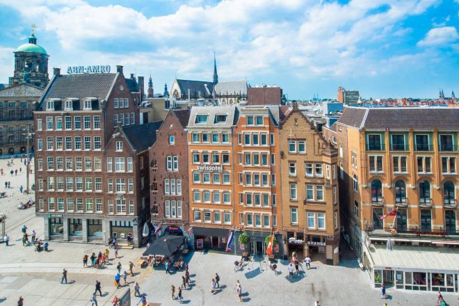 Een historisch plein met traditionele Europese architectuur, waaronder een hotel genaamd 'Swissotel' en een gebouw met de aanduiding 'ABIN-AMRO'.