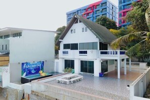 A two-story building with a balcony, a swimming pool, and a signboard. - Gao Bee One Beach Club (Ban Chang)