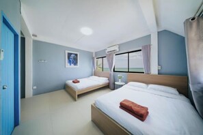 A hotel room with two beds, a window with curtains, a ceiling fan, and a wall-mounted air conditioner. - Gao Bee One Beach Club (Ban Chang)