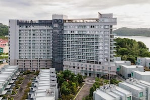 A high-rise building with multiple floors, a rooftop terrace, and a view of a body of water. - JD Luxury Lavanya Apartment (Langkawi)
