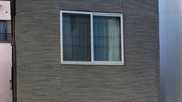 A modern building facade with a window and a door.