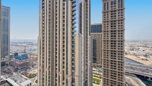 A high-rise building with a modern architectural design, featuring multiple floors and a prominent central tower. - bnbme Classic 1BR 8 mins to Burj Khalifa (Dubai)
