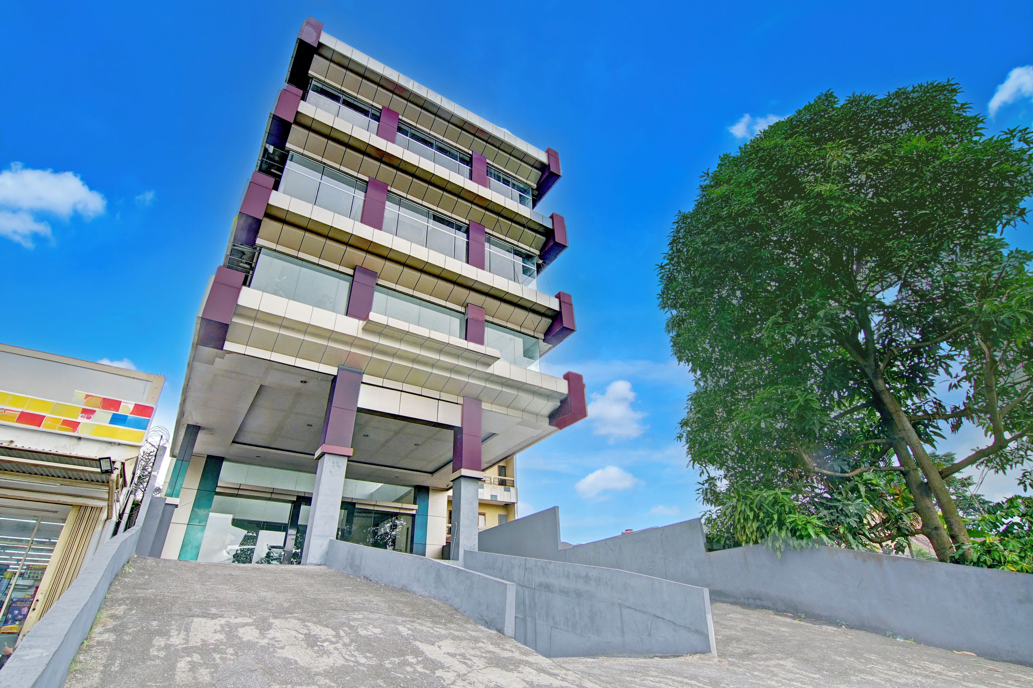 A multi-story building with a modern architectural design, featuring a series of balconies and large windows.