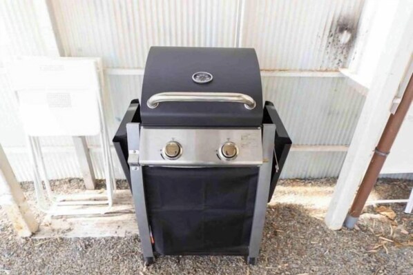 A portable grill with a control panel and a lid, placed outdoors. - Villa Biwako Hamabun (Takashima)