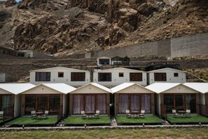 A row of modern, white-roofed cabins with large windows and outdoor seating areas. - Horizon Resort Hunza (Gilgit)