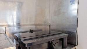 A stainless steel kitchen with a built-in oven and a small countertop. - Yokohama Chuo 2 House (Yokohama)