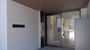 Ένας μοντέρνος εσωτερικός χώρος με μια γυάλινη πόρτα που οδηγεί σε μια τραπεζαρία.