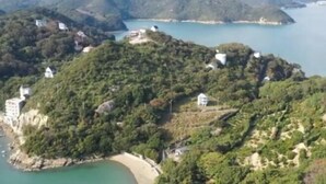 A coastal area with buildings on a hillside overlooking a bay. - Ultra Private Off Grid Island Villa Near the Beach Mandarin Farm Setting (Bizen)